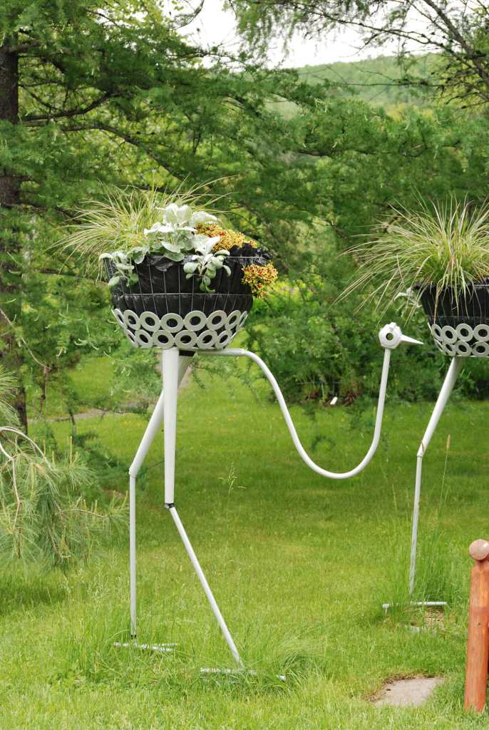 Bird garden ornament with a flower basket for the body.